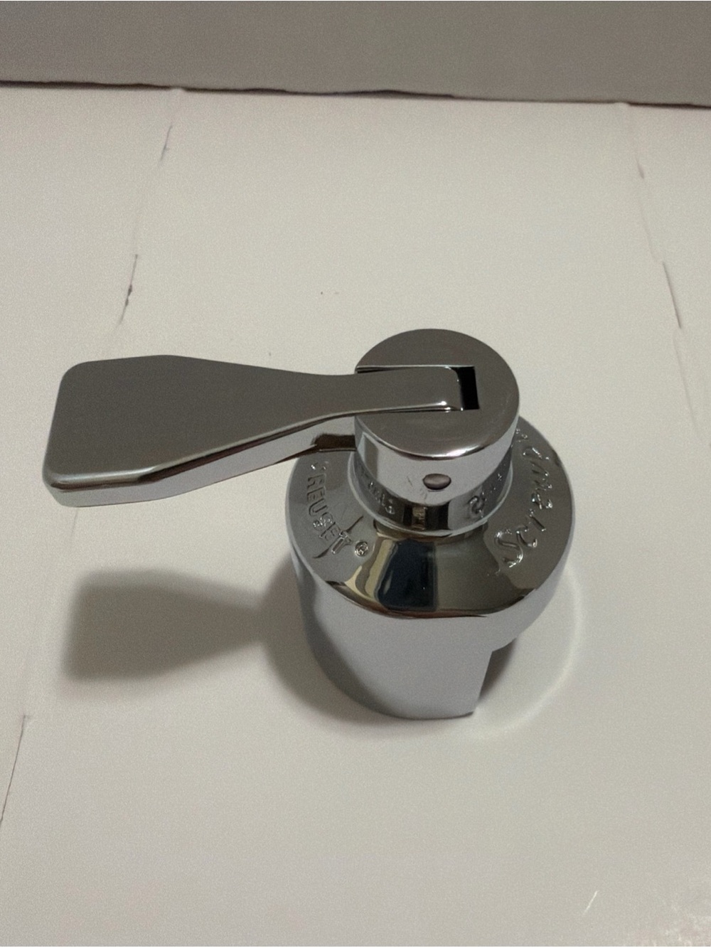 Le Creuset Champagne Crown Sealer, specifically a satin chrome.